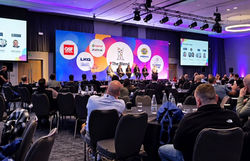 Panel discussion on stage at The Blend with garage owners at round tables